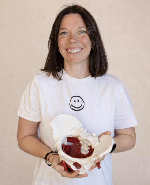 Professional studio portrait placeholder of female physiotherapist, navy-blue clinic uniform, bright clean clinic interior, soft daylight, friendly smile, head and shoulders, subtle bokeh background, accents matching #0b1f3a